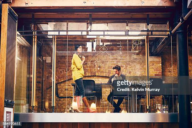 two employees work on a project in modern office - new business stock pictures, royalty-free photos & images