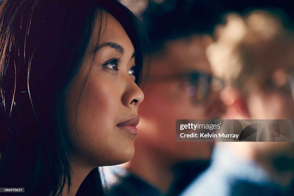 A young Asian professional watches presentation