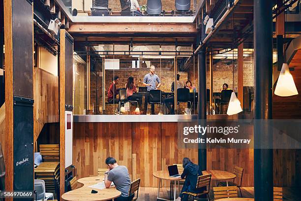 a team holds meeting in modern office space - work culture stock pictures, royalty-free photos & images