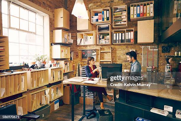 two colleagues chatting in modern office - office shelf stock pictures, royalty-free photos & images