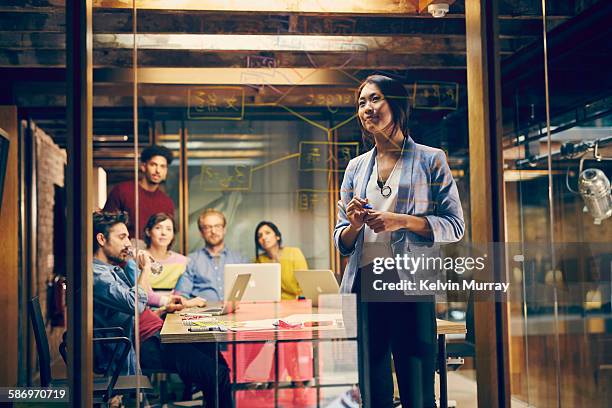 a creative team discuss targets in meeting - graphic artist stock pictures, royalty-free photos & images