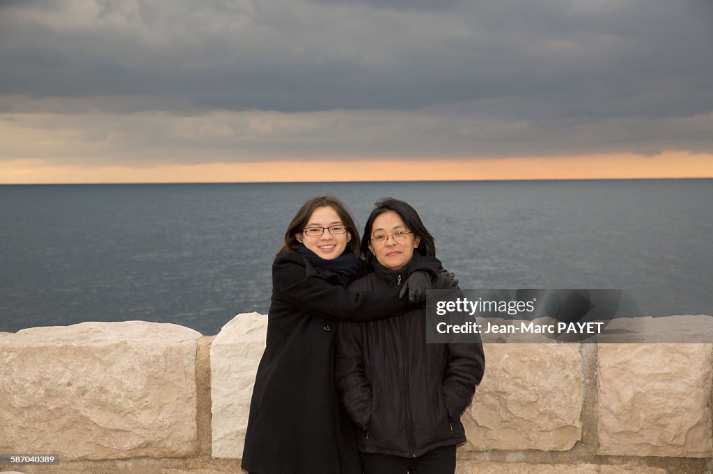 Portrait of mother and daughter hugging