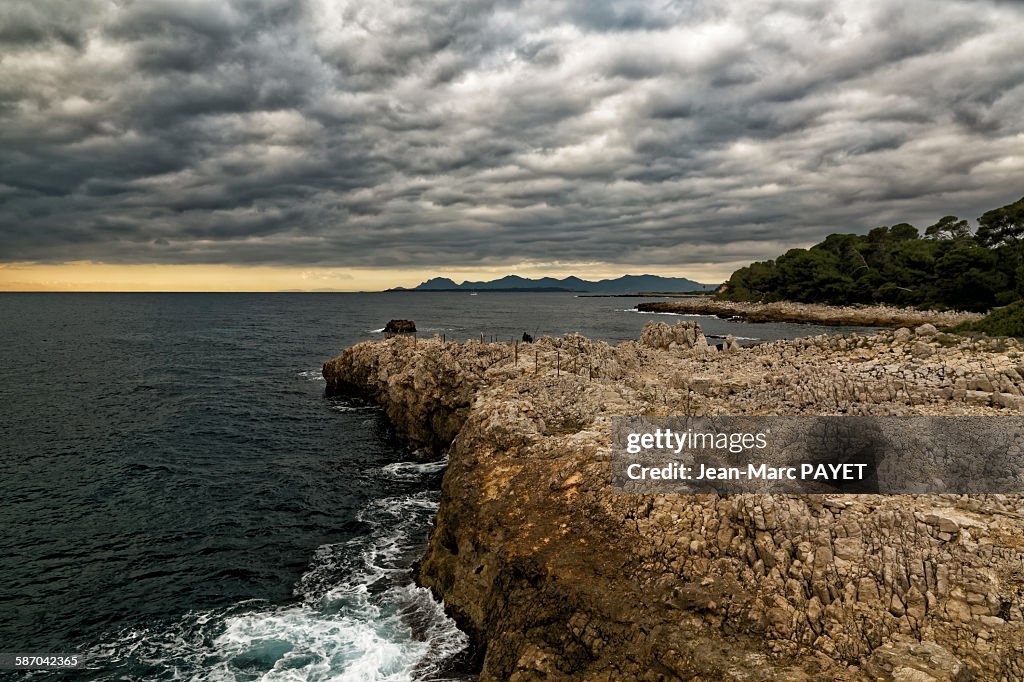 Seascape and sunset with cloudy sky