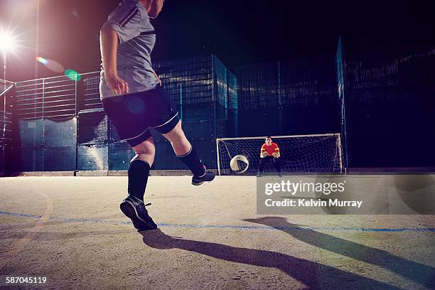 a female football player takes a shot in training - keeper stock pictures, royalty-free photos & images