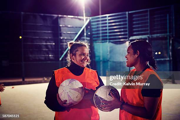Two women from ladies football team smiling