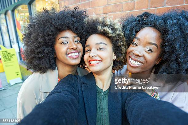 selfie of three young friends. - afro hairstyle stock pictures, royalty-free photos & images