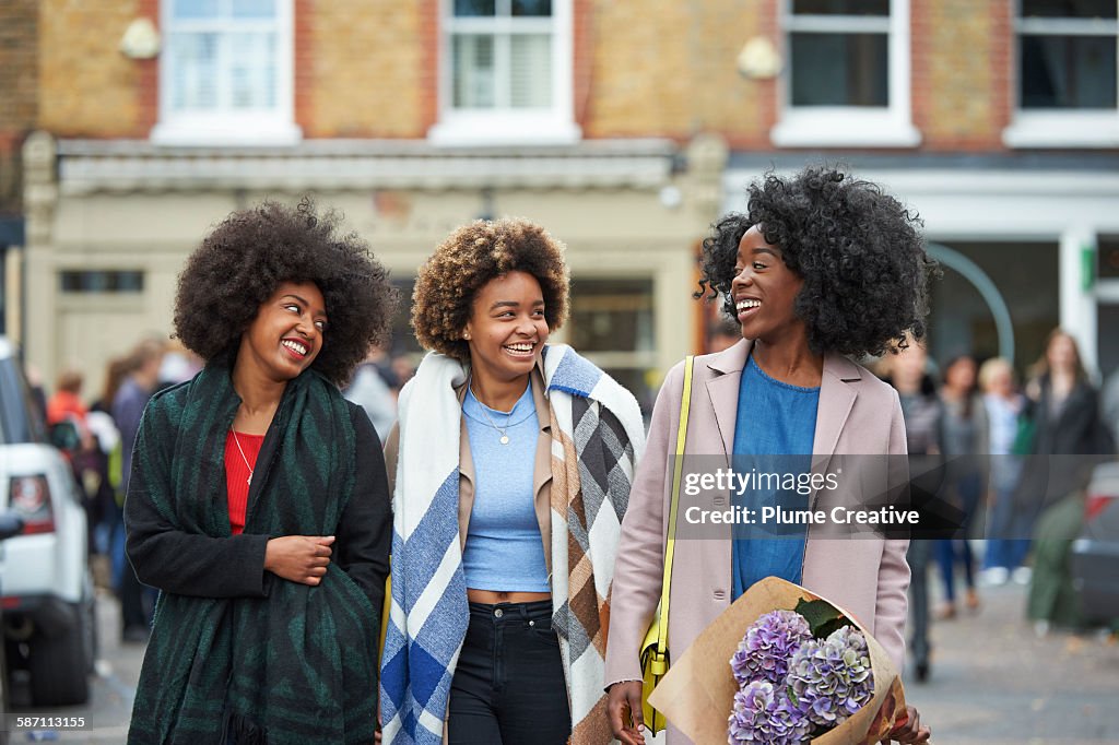 Group of friends walking down London street.