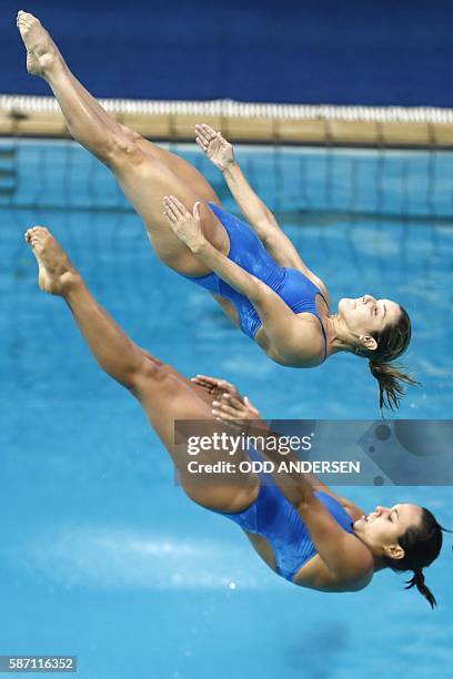 Brazil's Juliana Veloso and Brazil's Tammy Takagi compete in the Women's Synchronized 3m Springboard Final during the diving event at the Rio 2016...