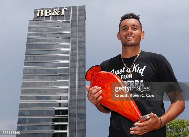 Nick Kyrgios of Australia poses with the trophy after defeating John Isner during the finals of the BB&T Atlanta Open at Atlantic Station on August...