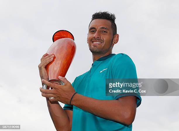 Nick Kyrgios of Australia poses with the trophy after defeating John Isner during the finals of the BB&T Atlanta Open at Atlantic Station on August...