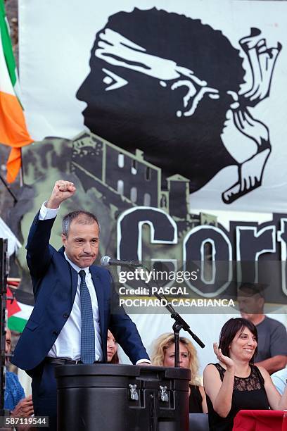 President of the Corsican assembly Jean Guy Talamoni holds up his fist at the end of a speech during the Ghjurnate Internaziunale di Corti on August...