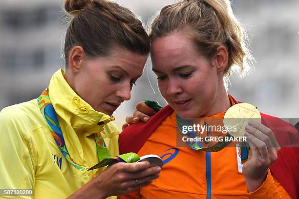 Silver medallist Sweden's Emma Johansson and Gold medallist Netherlands' Anna Van Der Breggen pose on the podium after the Women's road cycling race...