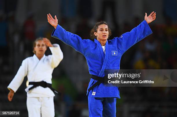 Majlinda Kelmendi of Kosovo celebrates winning the gold medal as Odette Giuffrida of Italy looks dejected during the Womens -52kg gold medal final...