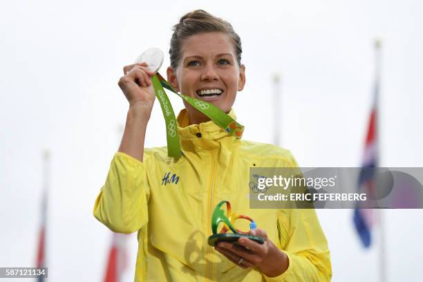 Silver medallist Sweden's Emma Johansson poses on the podium after the Women's road cycling race at the Rio 2016 Olympic Games in Rio de Janeiro on...