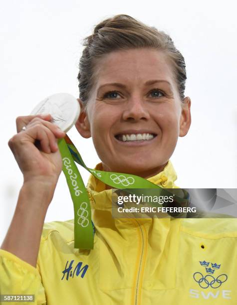 Silver medallist Sweden's Emma Johansson poses on the podium after the Women's road cycling race at the Rio 2016 Olympic Games in Rio de Janeiro on...