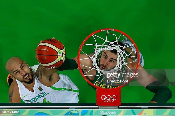 Jonas Valanciunas of Lithuania shoots over Marcus Vinicius Marquinhos of Brazil during a Men's preliminary round basketball game between Brazil and...