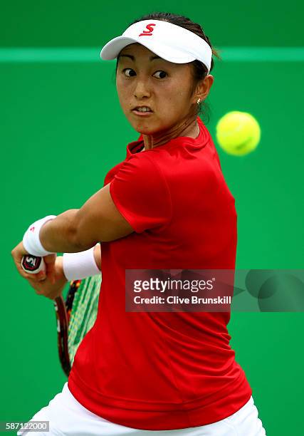 Misaki Doi of Japan plays a backhand against Yarolavia Shvedova of Kazakhstan during their first round singles match on Day 2 of the Rio 2016 Olympic...