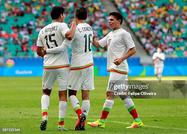 Michael Perez of Mexico celebrates with teammates Carlos Cisneros and Arturo Gonzalez during the Men's First Round Group C match between Fiji and...