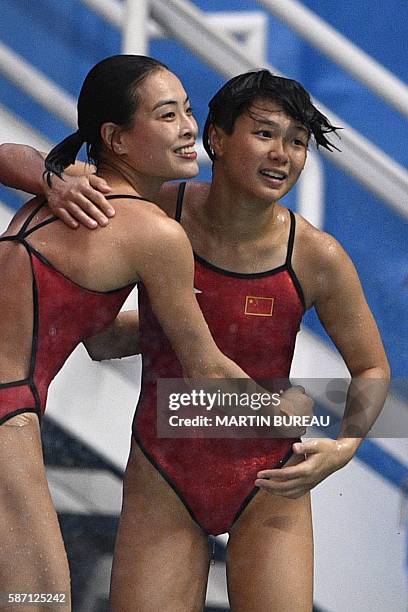 China's Wu Minxia and China's Shi Tingmao celebrate as they compete in the Women's Synchronized 3m Springboard Final during the diving event at the...