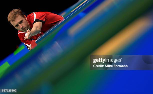 Jakub Dyjas of Poland plays a Men's Singles second round match against Alexander Shibaev of Russia on Day 2 of the Rio 2016 Olympic Games at...