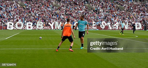 The letters for the Bobby Moore Stand are moved away at London Stadium on Queen Elizabeth Olympic Park prior to the friendly match between West Ham...