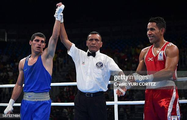 Armenia's Vladimir Margaryan looks on as he announced the winner against Fiji's Winston Hill during the Men's Welter match at the Rio 2016 Olympic...