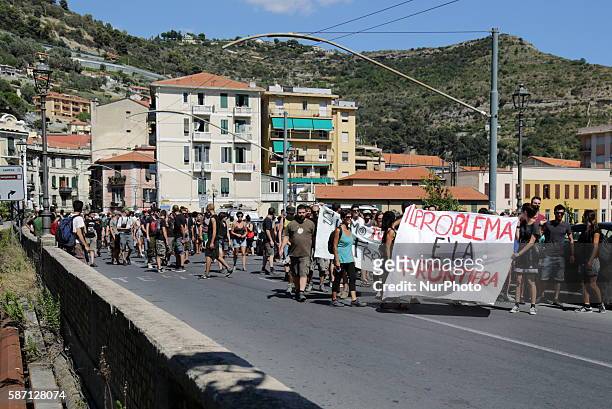 &quot;No borders&quot; movement activists hold a banner which translates as &quot;The problem is the border&quot; during a demonstration, on August 7...