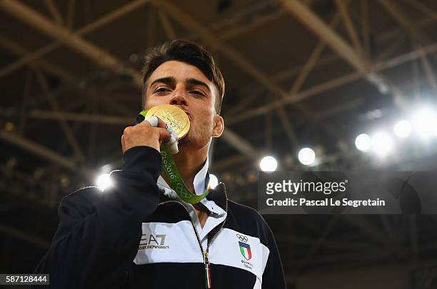Gold medalist Fabio Basile of Italy stands on the podium during the medal ceremony for the Men's -66kg Judo on Day 2 of the Rio 2016 Olympic Games at...