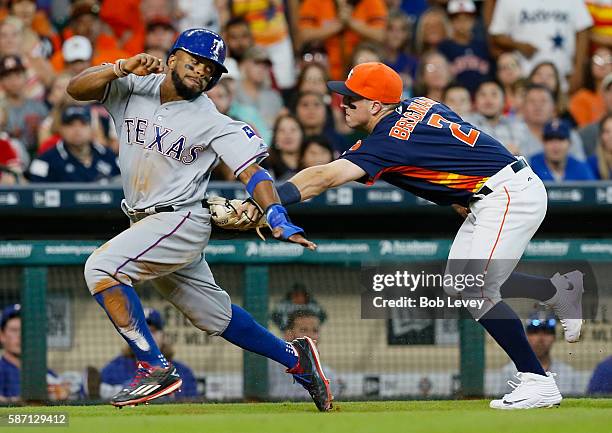 Delino DeShields of the Texas Rangers is tagged out by Alex Bregman of the Houston Astros after being caught in a run down in the eighth inning at...