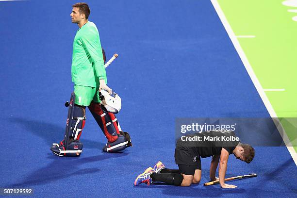 George Pinner of Great Britain walks away as Nick Wilson New Zealand tries to get to his feet after a heavy collision during the men's pool A match...