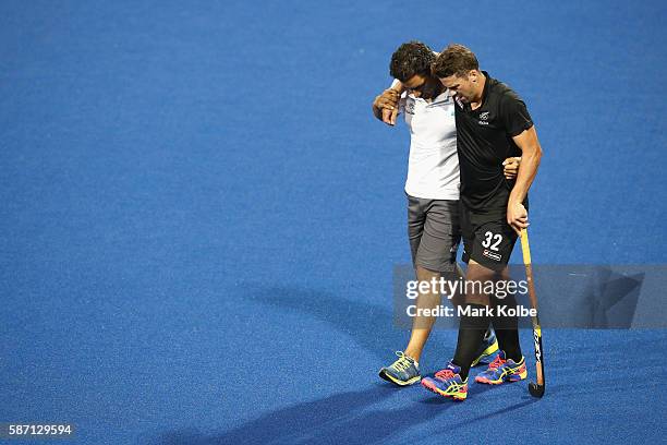 Nick Wilson New Zealand is helped from the pitch after a heavy collision during the men's pool A match between Great Britain and New Zealand on Day 2...