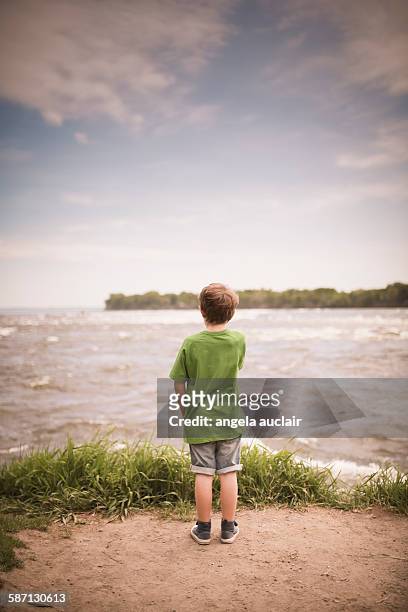 young boy watching the rapids - angela auclair stock pictures, royalty-free photos & images
