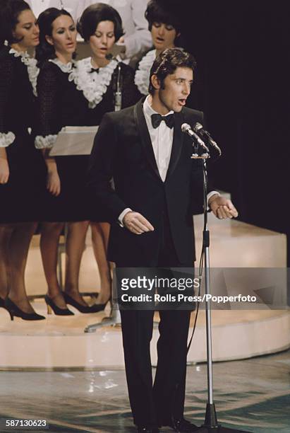 French singer Sacha Distel performs live on stage at the Sanremo Music Festival in Sanremo Casino, Italy in 1968.