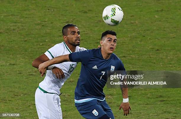 Argentina player Cristian Pavon vies for the ball with Algeria player Houari Ferhani during the Rio 2016 Olympic Games men's First Round Group D...