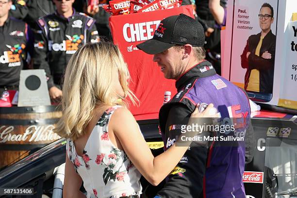 Denny Hamlin, driver of the FedEx Freight Toyota, celebrates in victory lane with girlfriend Jordan Fish after winning the NASCAR Sprint Cup Series...