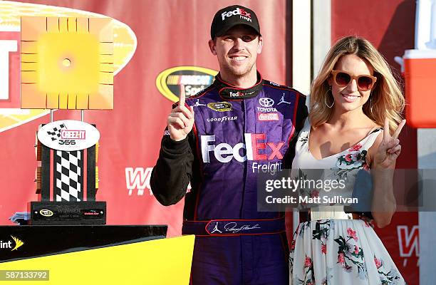 Denny Hamlin, driver of the FedEx Freight Toyota, celebrates in victory lane with girlfriend Jordan Fish after winning the NASCAR Sprint Cup Series...