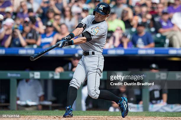 Ichiro Suzuki of the Miami Marlins hits a triple off of Chris Rusin of the Colorado Rockies for the 3,000th hit of his major league career in the...