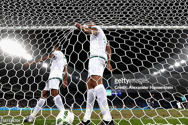 Team captain Abdelghani Demmou of Algeria and his team mate Houari Ferhani react after receiving the 2nd goal during the Men's Group D first round...