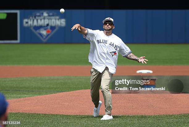 Michael Pillar the brother of Kevin Pillar of the Toronto Blue Jays throws out the first pitch before the start of MLB game action against the...