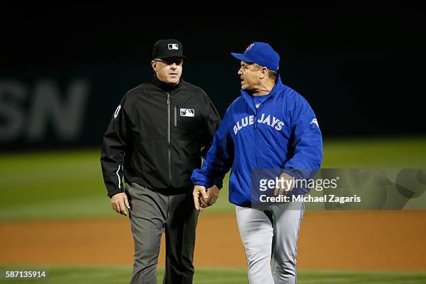 Manager John Gibbons of the Toronto Blue Jays argues with Umpire Paul Emmel during the game against the Oakland Athletics at the Oakland Coliseum on...