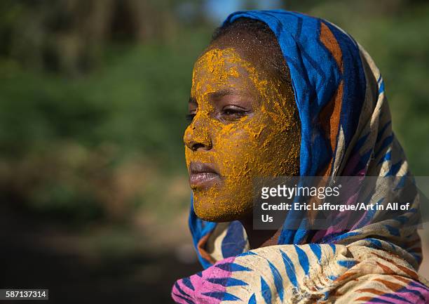 Afar tribe teenage girl with qasil on her face, afar region, afambo, Ethiopia on March 1, 2016 in Afambo, Ethiopia.