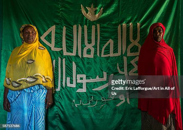 Sufi women worshippers in front of islamic flag, harari region, harar, Ethiopia on March 4, 2016 in Harar, Ethiopia.