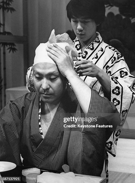 Japanese Kabuki actor Ichikawa Ennosuke III dons his costume for a dress rehearsal at Sadler's Wells in London, UK, October 1981.