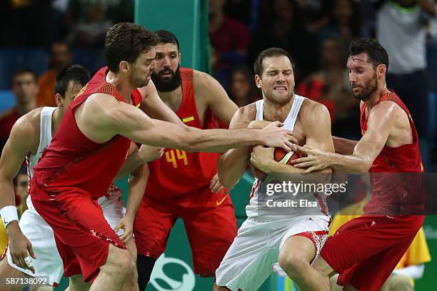 Bojan Bogdanovic of Croatia and Pau Gasol of Spain fight for a rebound during a Men's preliminary round basketball game between Croatia and Spain on...