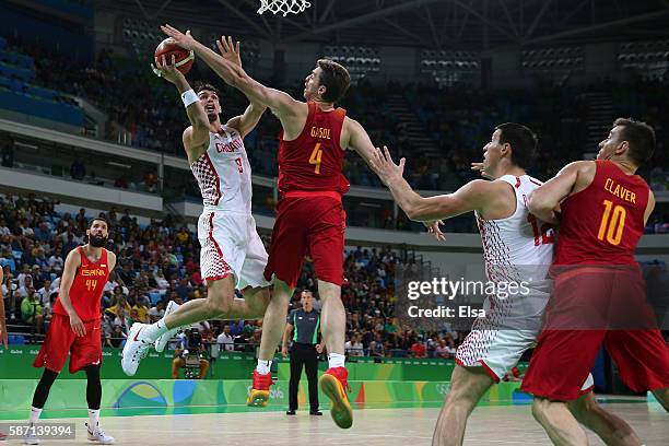 Pau Gasol of Spain blocks a shot by Dario Saric of Croatia during a Men's preliminary round basketball game between Croatia and Spain on Day 2 of the...