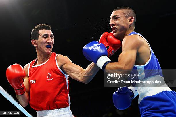 Sofiane Oumiha of France lands a punch on Teofimo Andres Lopez Rivera of Honduras as they compete in the Men's Light 60kg preliminary bout on Day 2...