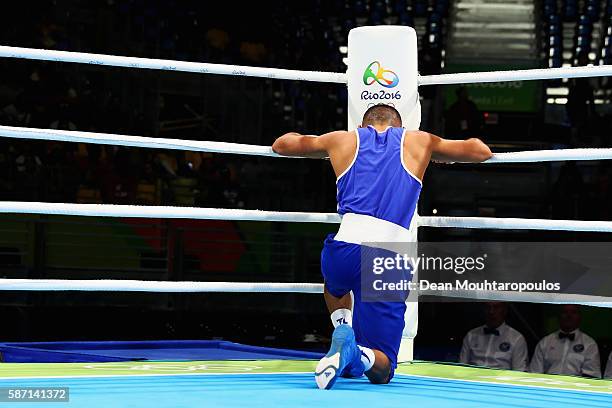 Teofimo Andres Lopez Rivera of Honduras prays after his fight with Sofiane Oumiha of France in the Men's Light 60kg preliminary bout on Day 2 of the...