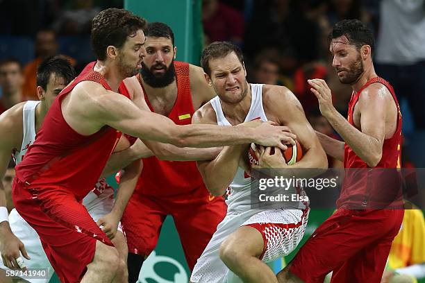 Bojan Bogdanovic of Croatia and Pau Gasol of Spain fight for a rebound during a Men's preliminary round basketball game between Croatia and Spain on...