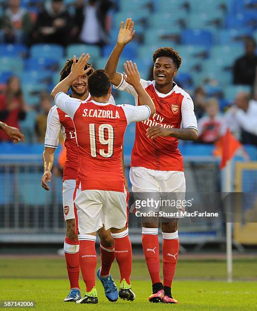 Chuba Akpom celebrates scoring the 3rd Arsenal goal with Mohamed Elneny and Santi Cazorla during the pre season friendly between Arsenal and...