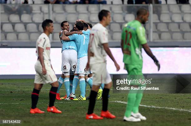 Santiago Silva of Sporting Cristal celebrates with teammates after scoring the second goal of his team against Universitario during a match between...